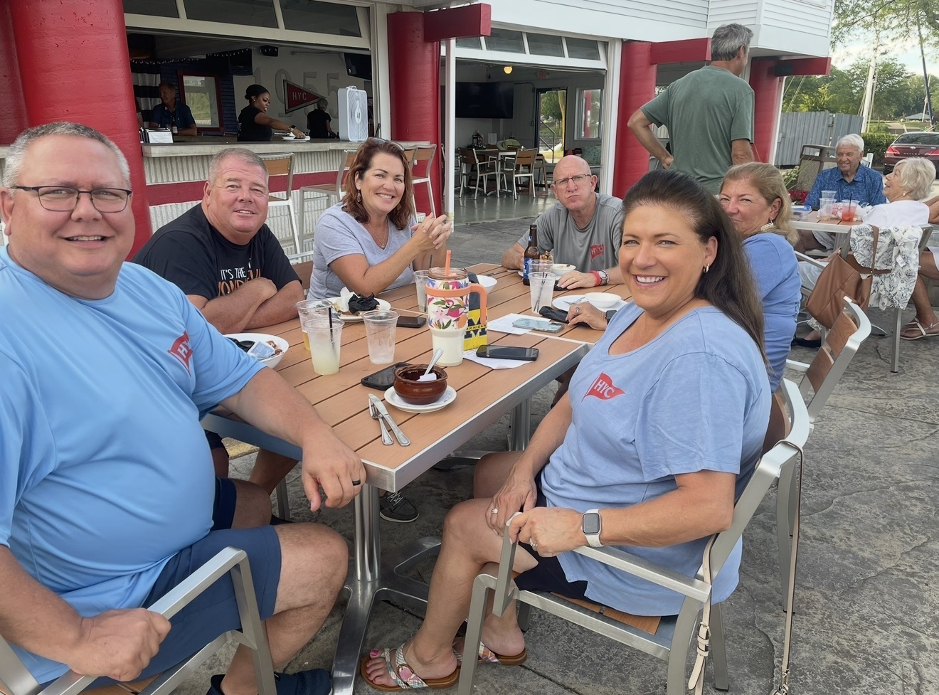 Members enjoying food and drinks at the open-air patio bar